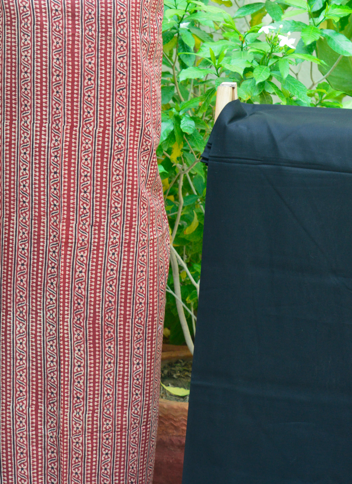 Handcrafted Ajrak two-piece with red stripes and black trouser in organic dye — breathable lawn fabric.