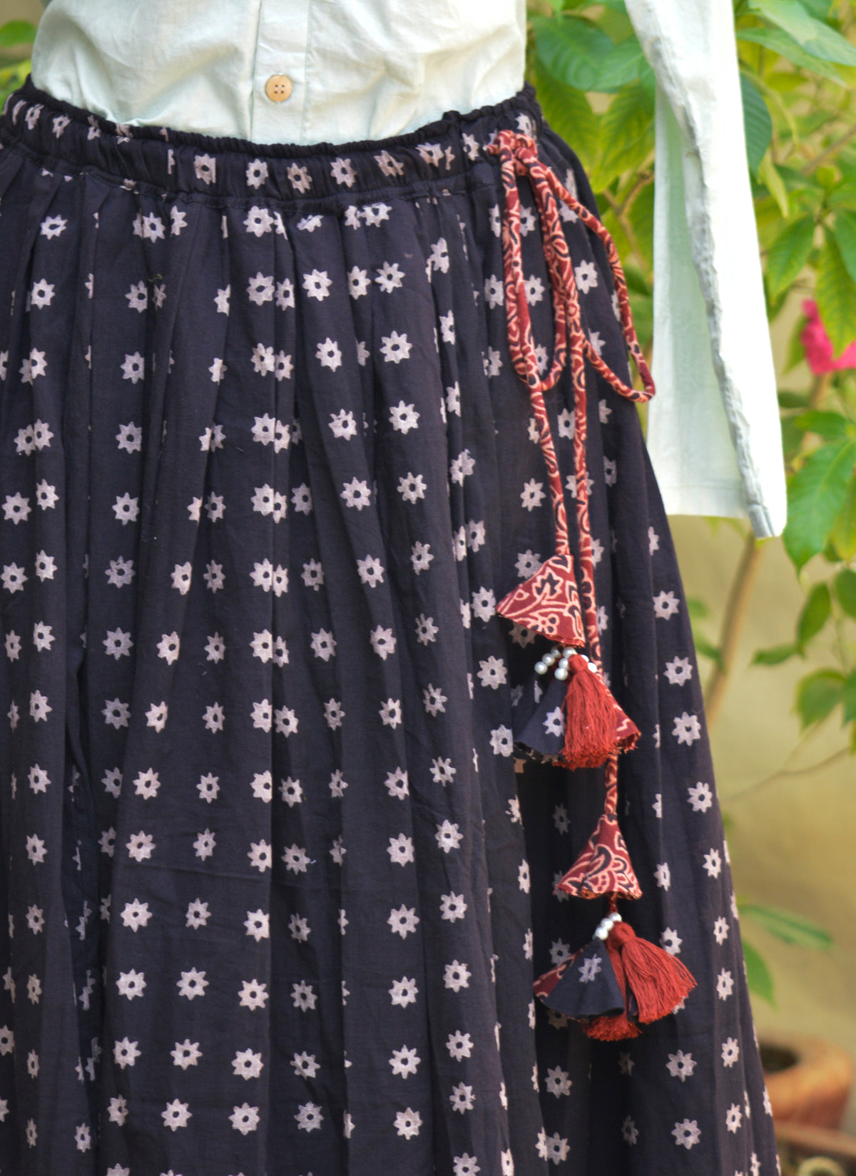 Handmade black Ajrak skirt for women with red floral motifs and tassel waist dori