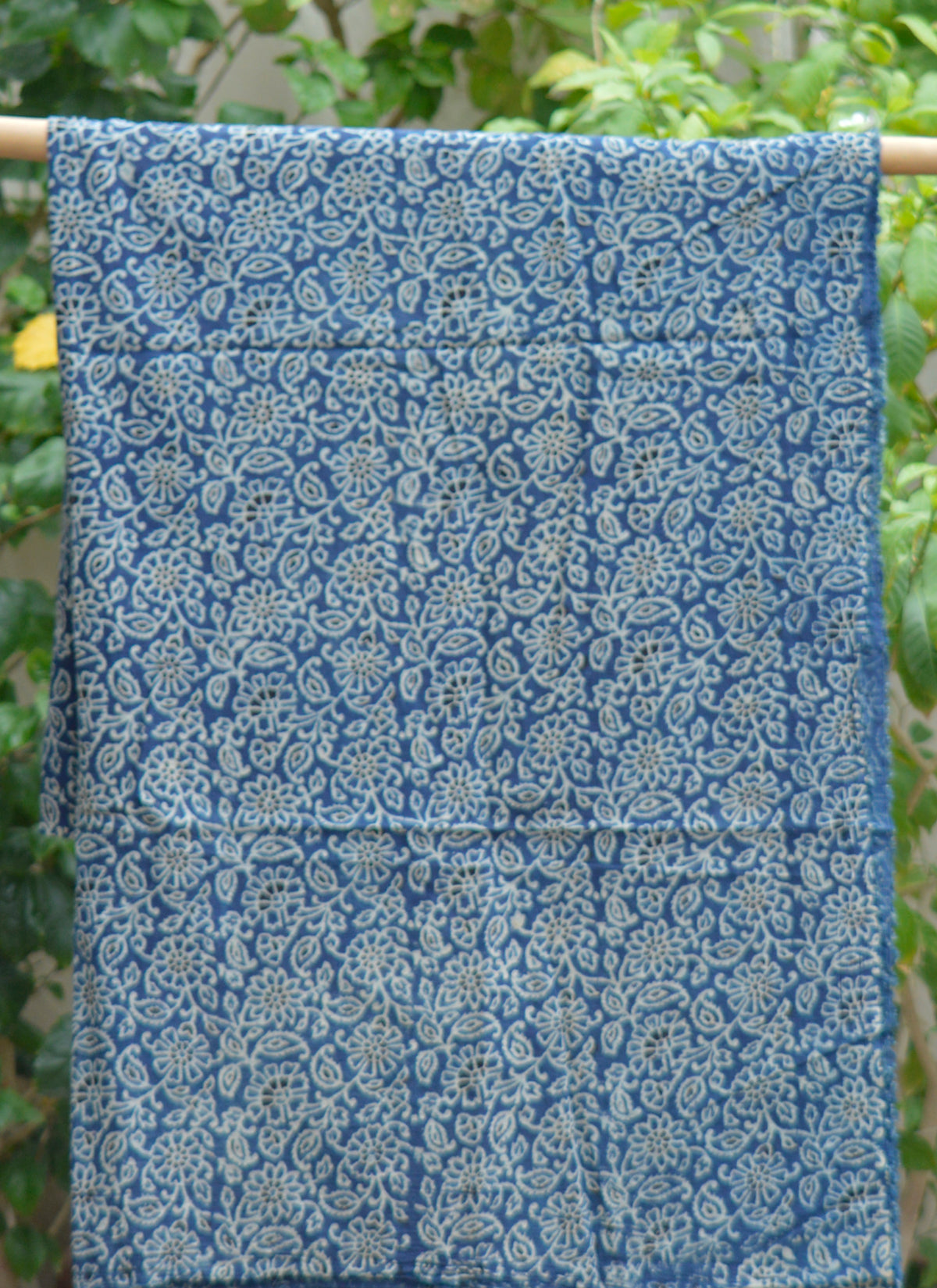 Premium lawn Ajrak fabric featuring floral bel motifs for custom tailoring projects