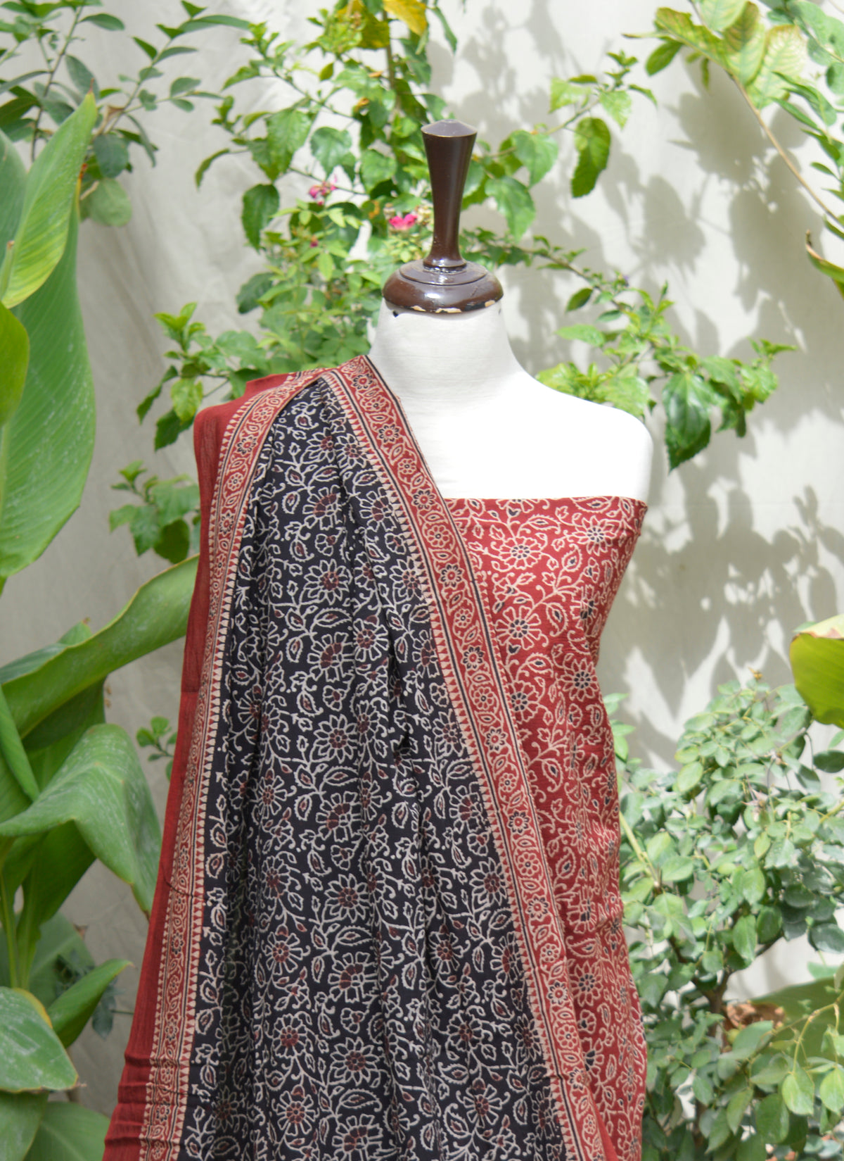 Traditional Sindhi Ajrak two-piece set featuring red and black floral motifs on breathable lawn cotton