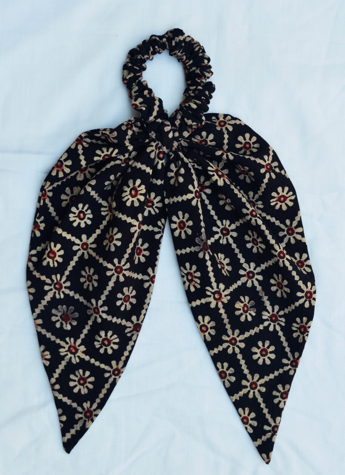 Organic cotton Ajrak hair scrunchie in floral pattern, handmade accessory with eco-friendly natural dyes.