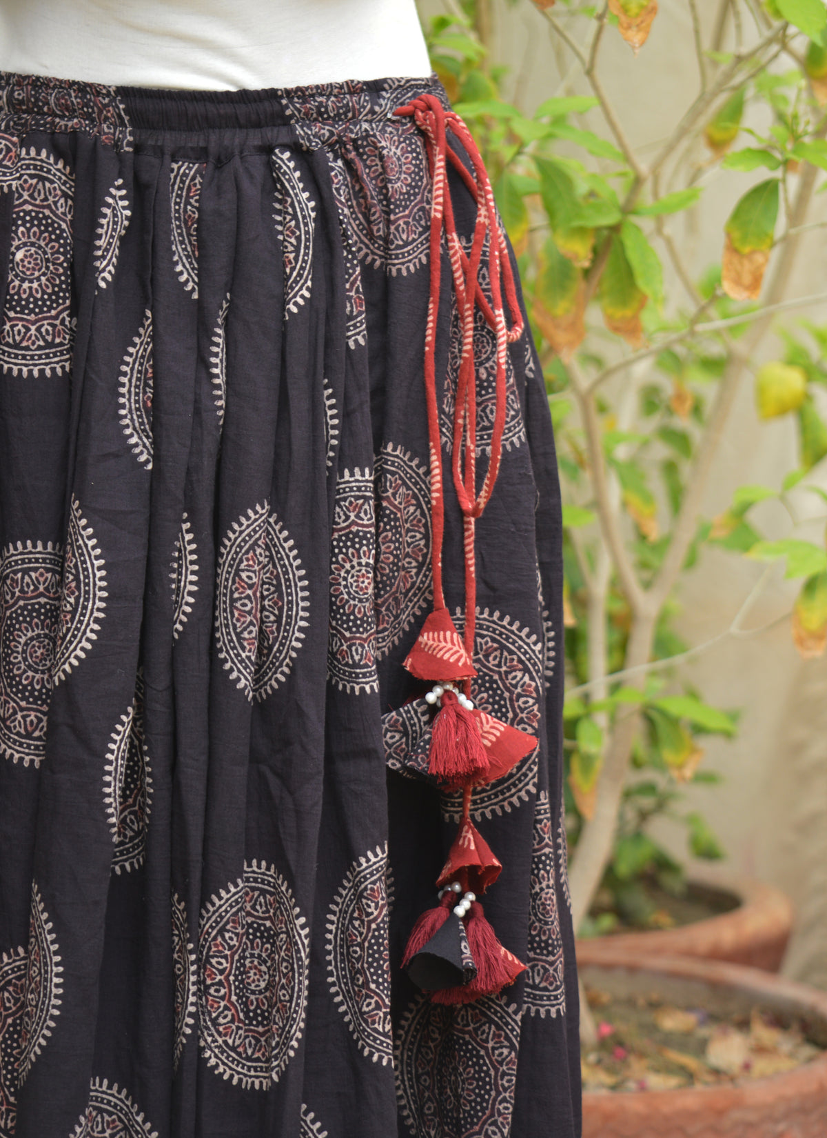 Handmade Sindhi Ajrak skirt with black chakra pattern, maroon accents, and thread tassel dori