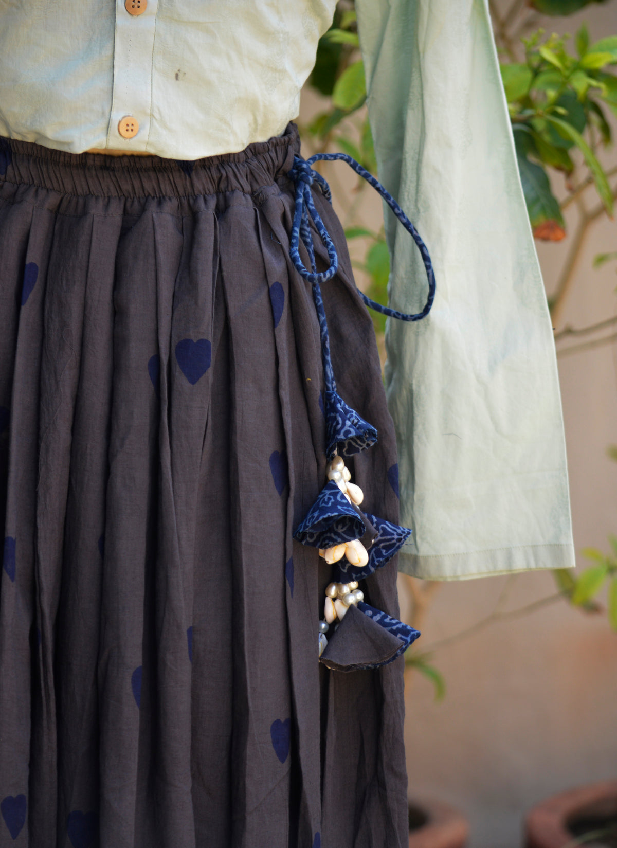 Premium lawn Ajrak skirt with blue floral dori and shell ornaments