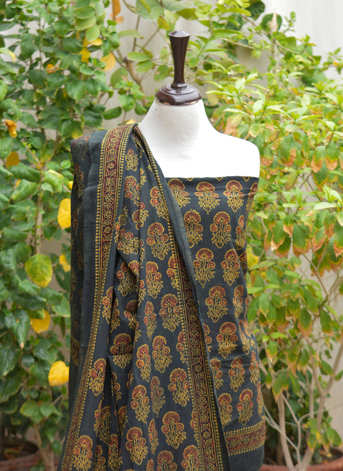 Premium lawn Ajrak Design Dress featuring green floral butta with maroon filling, handcrafted using traditional organic dye block printing