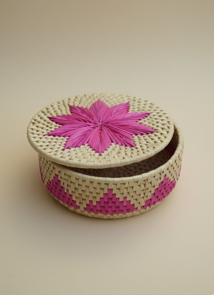 Pink palm-leaf bread basket with flower design handmade by Sindhi women artisans sustainable décor