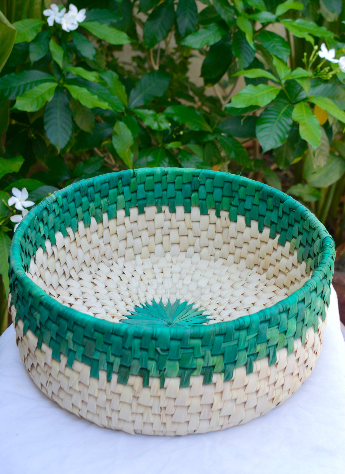 Eco-friendly date palm leaf roti dan bread basket featuring green flower design and blue floral accents for serving bread or rotis.