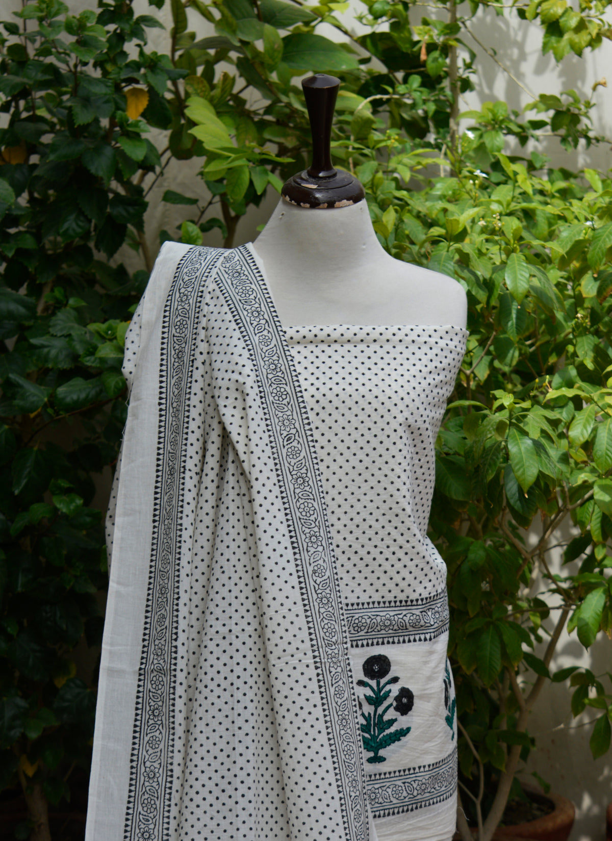 Unstitched cotton two-piece fabric featuring black dots pattern and floral butta border