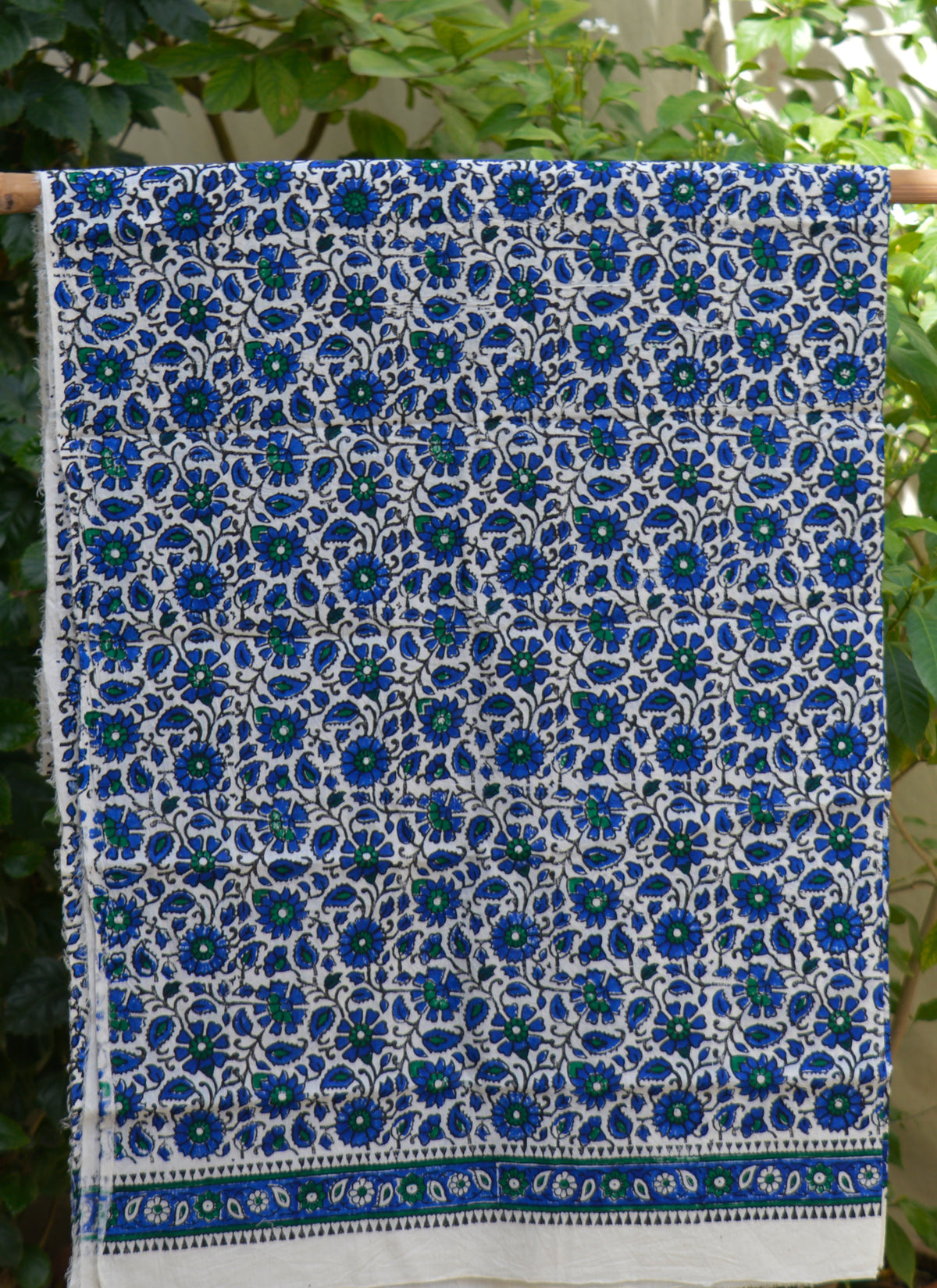 Traditional floral blue cotton fabric with artisan hand block print design