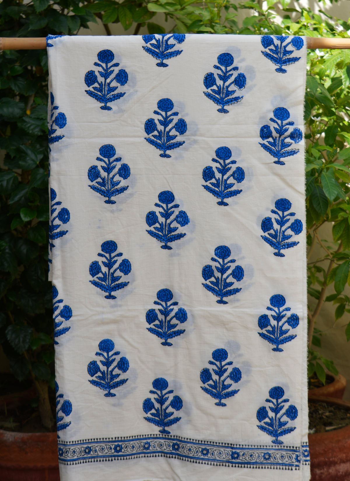 Artisan hand block printed cotton fabric for dresses and kurtas in floral butta pattern