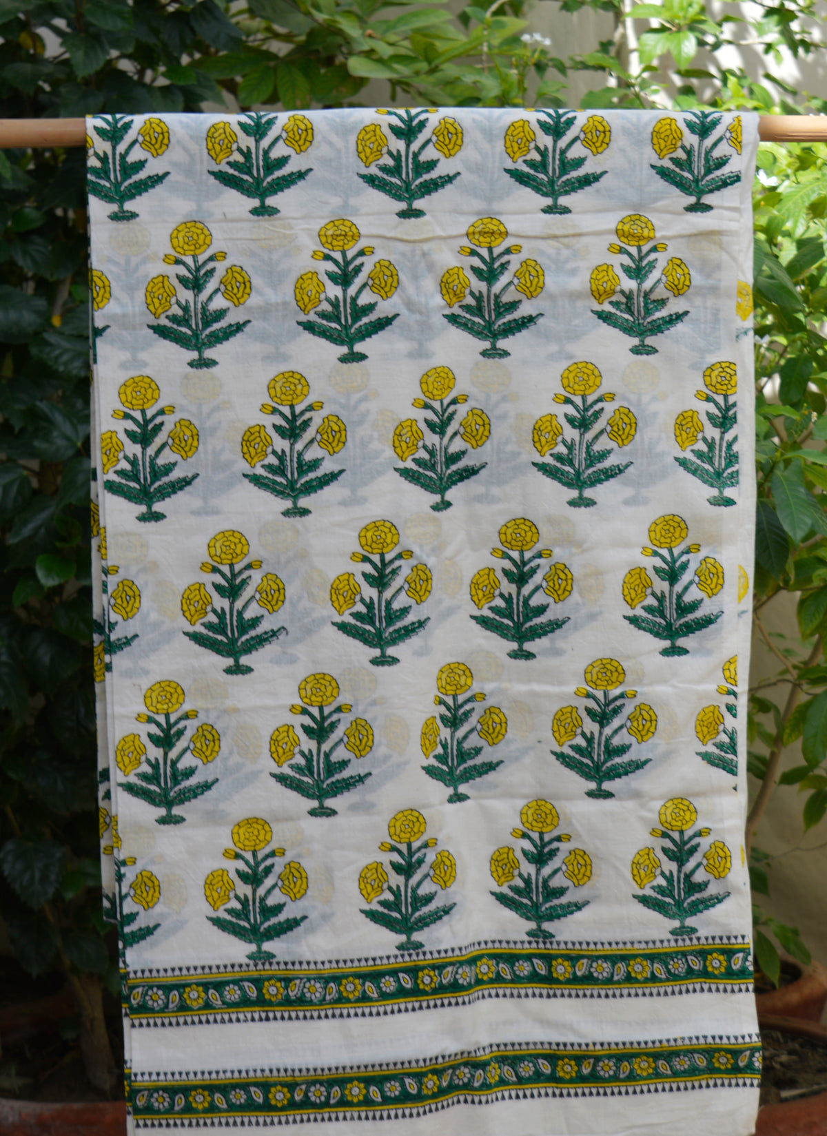Artisan hand block printed cotton fabric for dresses and kurtas in floral butta pattern
