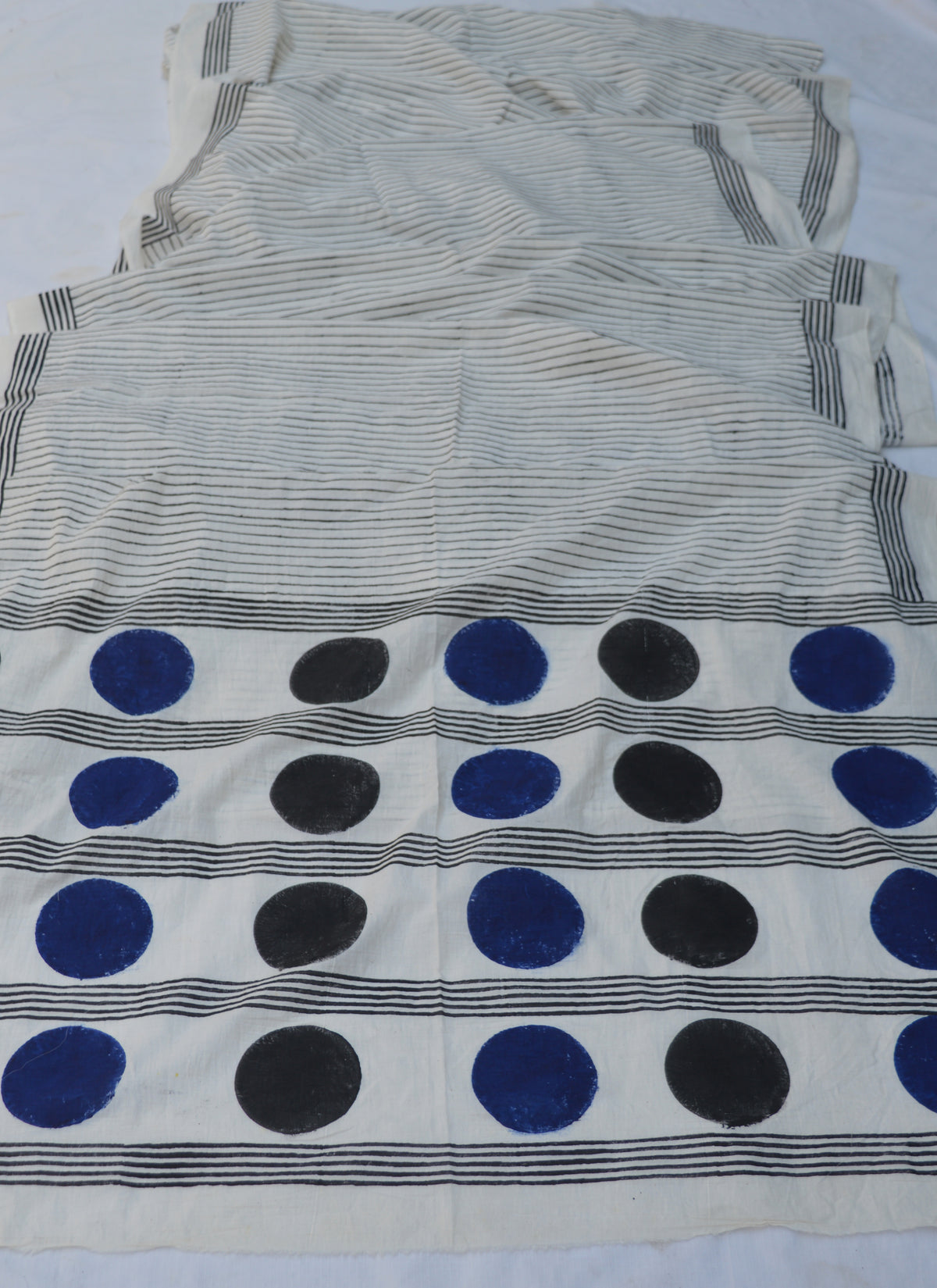 Offwhite Black Stripe Ajrak Cotton Saree with alternating solid Blue and Black Circle designs