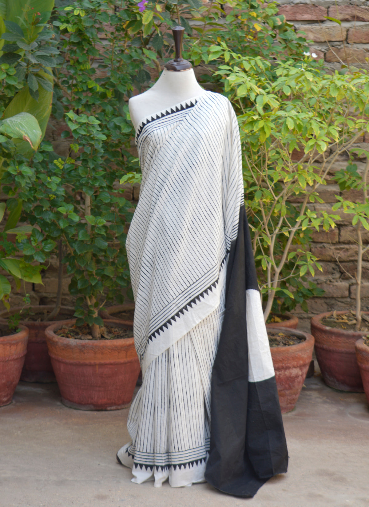 Traditional hand block printed black cotton saree with geometric border