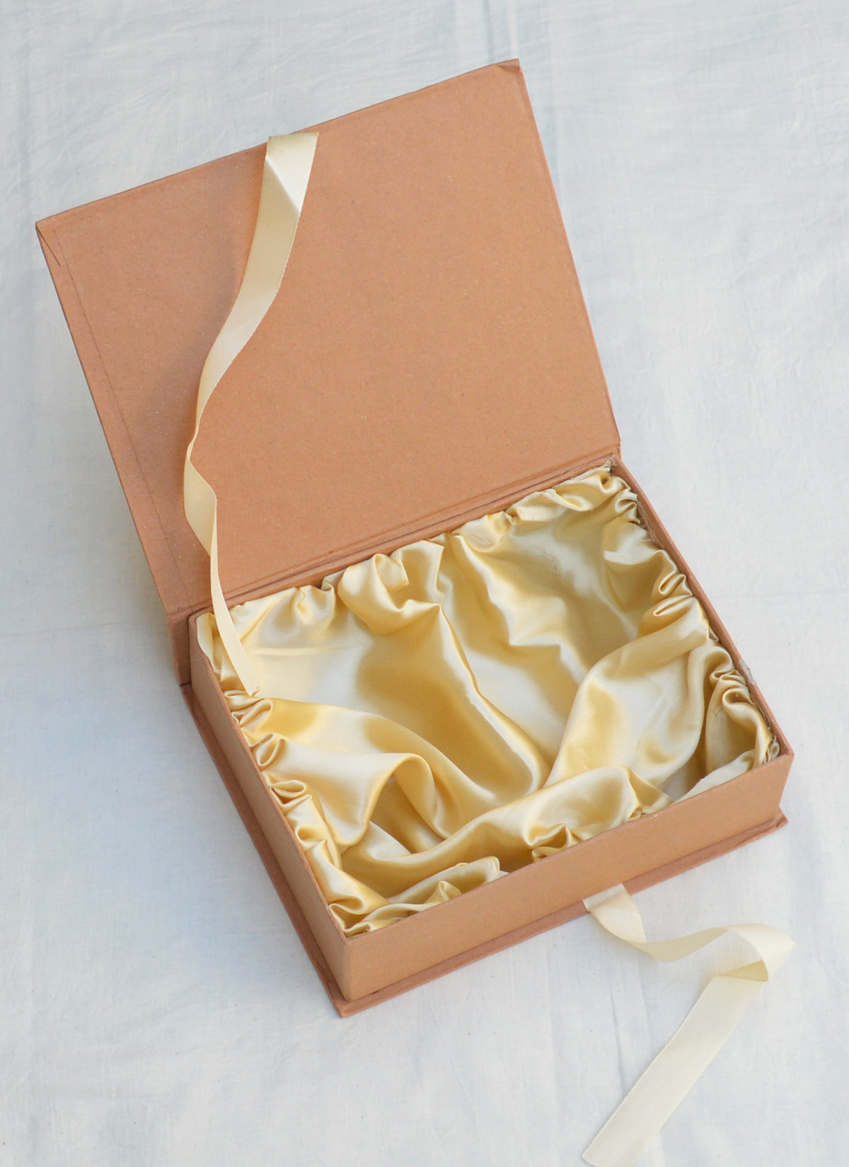 Luxury golden satin gift box with elegant lining – perfect for premium gift packaging.