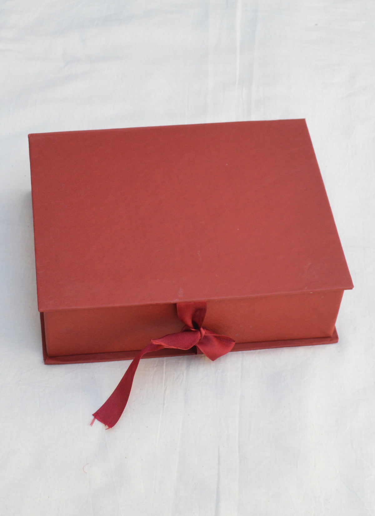 Elegant and sturdy maroon satin gift box for luxury packaging and presentation.
