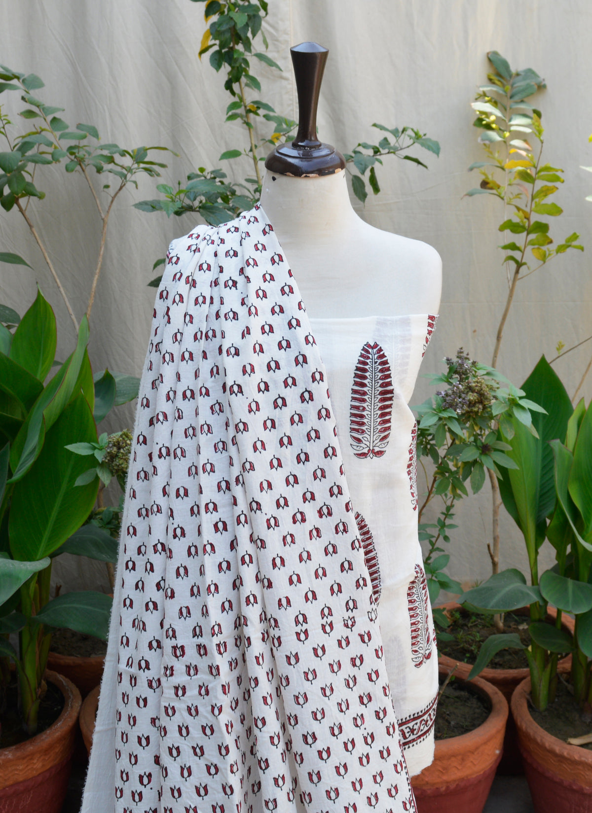 Traditional block print dress with maroon floral and geometric designs on white base