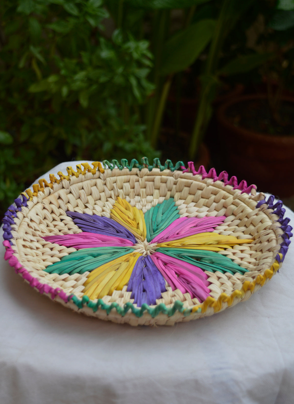 Hand woven palm leaf changair bread plate flower multi-color design, 11x11 inches.
