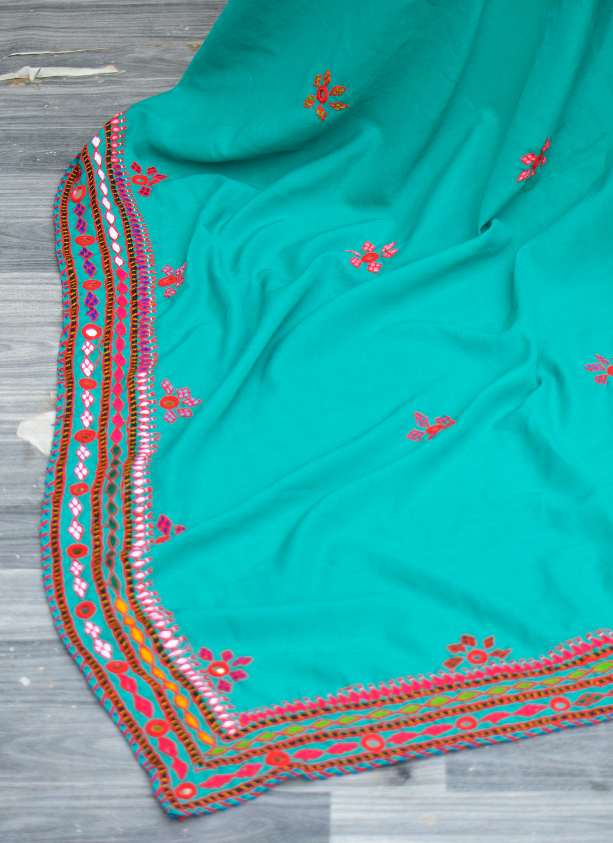 Hand embroidered sea green Sindhi chadar with mirror work laid out flat