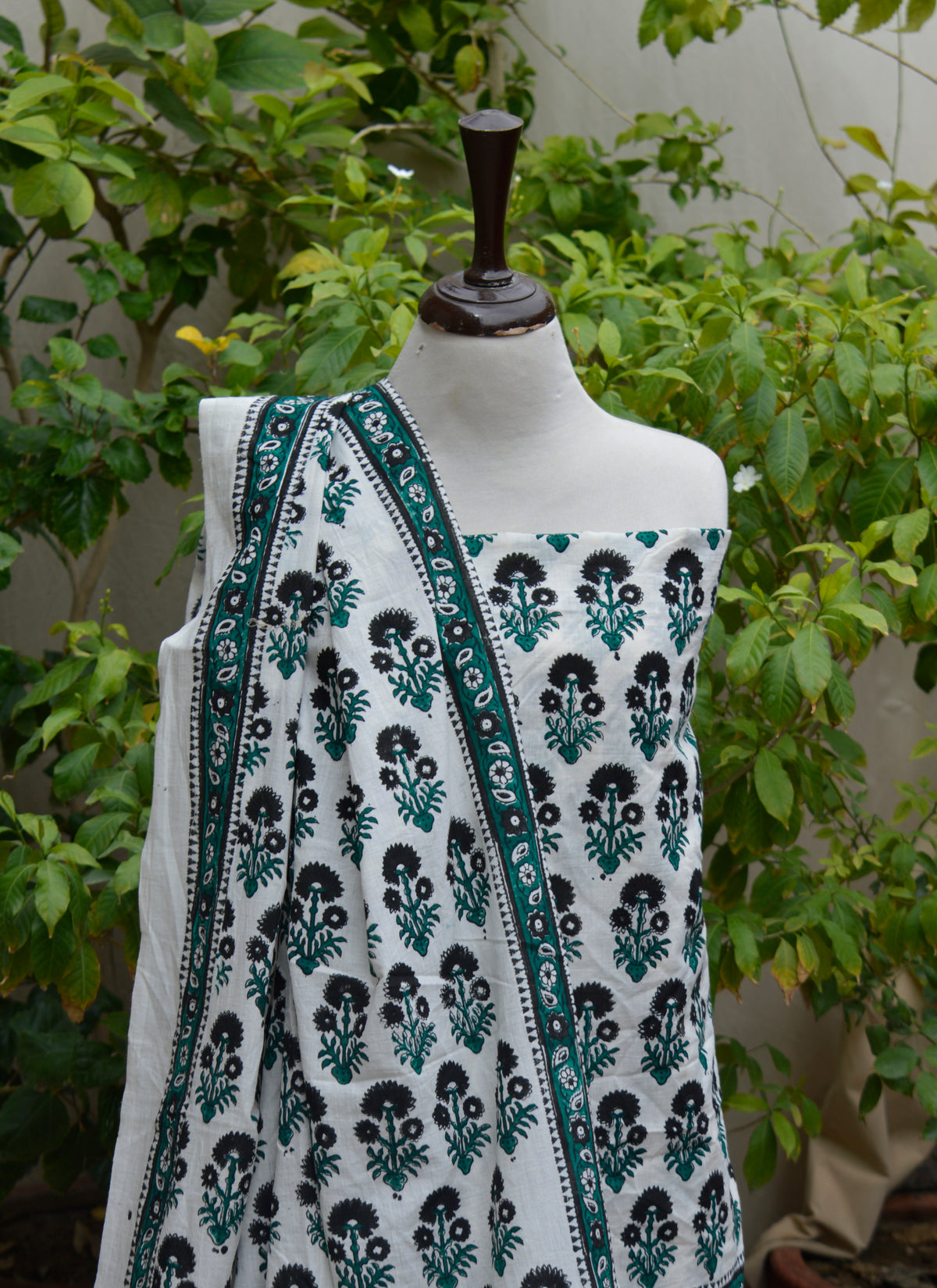 Traditional floral hand block print cotton dress material with black flowers and green stems
