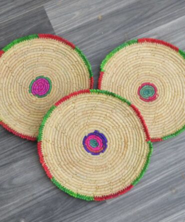 Lightweight and durable palm leaf changairs arranged on a rustic wooden table for dining use.