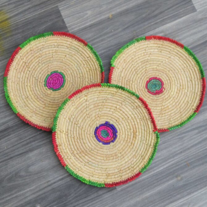 Lightweight and durable palm leaf changairs arranged on a rustic wooden table for dining use.