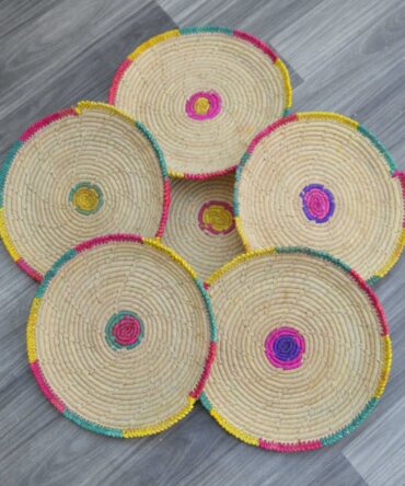 Set of six handwoven palm leaf changairs with intricate patterns, ideal for serving bread or snacks.