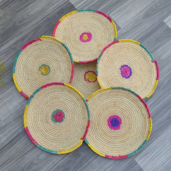 Set of six handwoven palm leaf changairs with intricate patterns, ideal for serving bread or snacks.