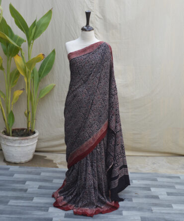 Close-up of a handcrafted Ajrak Saree with intricate floral patterns in a vibrant contrast of colors, showcasing the traditional Sindhi hand block printing technique.