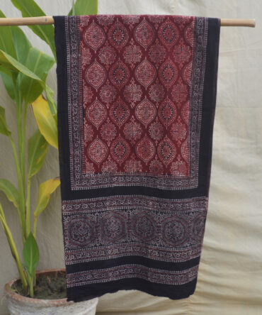 The Badam Ajrak Scarf displayed flat, emphasizing its detailed craftsmanship and vibrant patterns inspired by centuries-old Ajrak printing techniques.