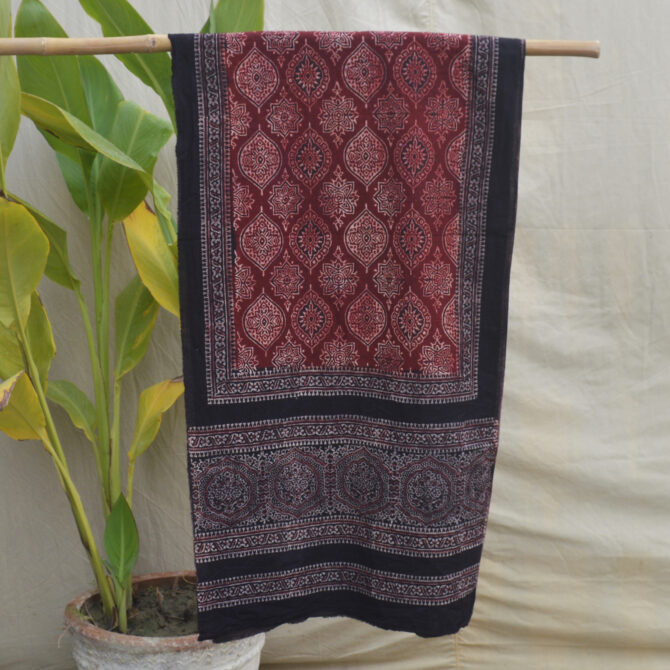 The Badam Ajrak Scarf displayed flat, emphasizing its detailed craftsmanship and vibrant patterns inspired by centuries-old Ajrak printing techniques.