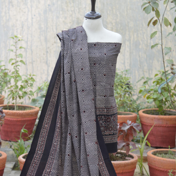 An unstitched two-piece ensemble including a hand block-printed shirt and dupatta. Made using organic dyes, the intricate Ajrak print showcases centuries-old craftsmanship, offering both beauty and sustainability.