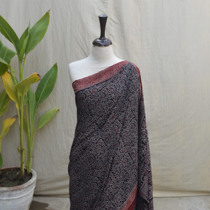 A Dummy draped in a stunning Ajrak Saree with floral motifs, dyed using eco-friendly, natural dyes, blending heritage with modern elegance.