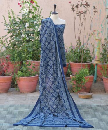 A beautifully crafted Organic Dye Hand Block Printed Ajrak Indigo Minaar two-piece unstitched set, featuring a richly patterned shirt and dupatta in deep indigo tones, laid out neatly to showcase the intricate detailing.