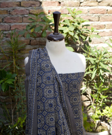 Ajrak Grey Floral, Close-up image of intricate hand block printed Ajrak patterns on soft lawn cotton fabric in deep grey and blue tones.