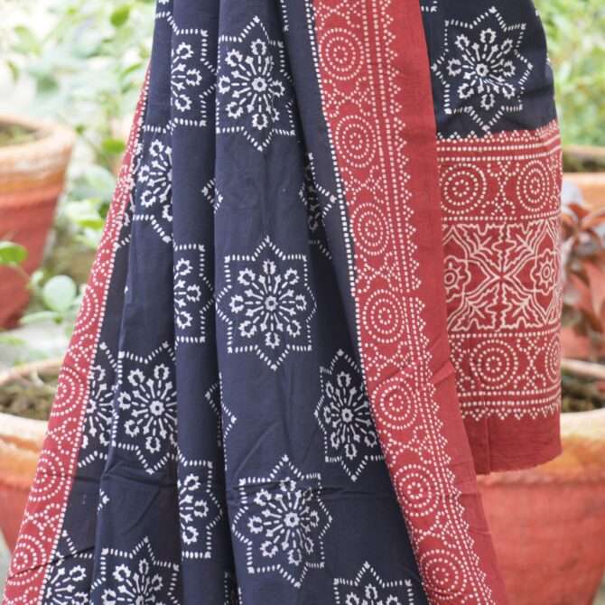 Artisan at work showcasing the traditional hand block printing technique used in creating the Organic Dye Hand Block Printed Ajrak Black Starry Un-Stitched Two-Piece.