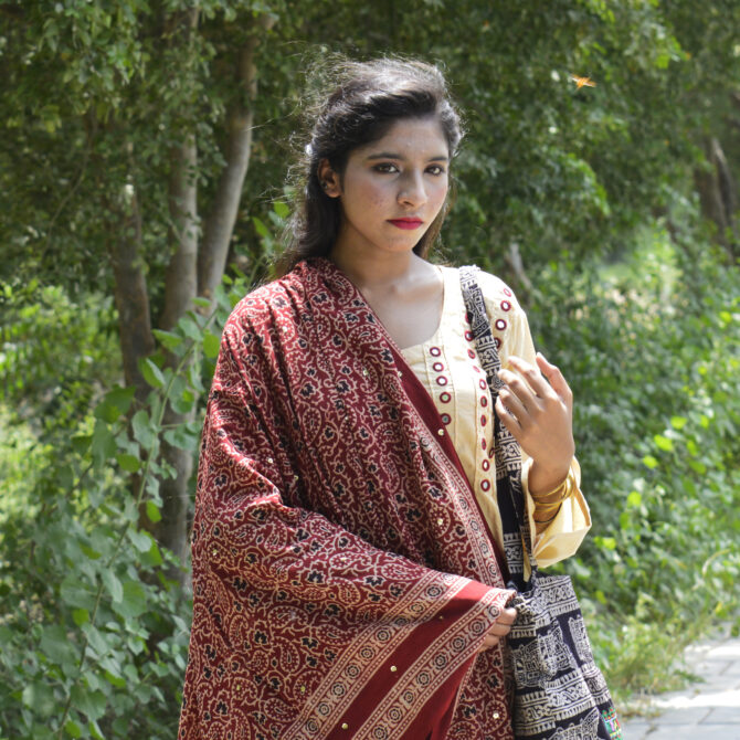 Organic Dye Hand Block Printed Ajrak Odhni Chinar Leaf showcasing intricate mehroonish red patterns with shimmering sitara sequences and thread tassels.