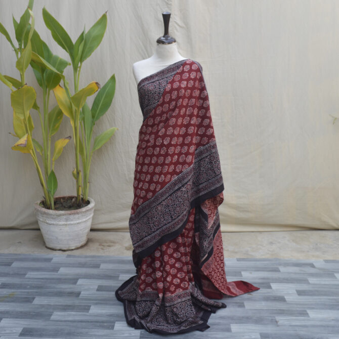 A beautiful Ajrak Saree Floral featuring intricate hand-printed patterns in vibrant colors, blending traditional craftsmanship with modern design.