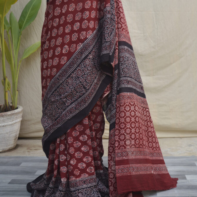 Close-up of an Ajrak Saree Floral, showcasing its detailed floral motifs and the rich hues of the Ajrak printing technique.