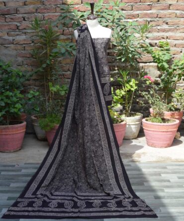 Ajrak Anbi Jaal Black Unstitched Two-Piece Set Display – A beautiful unstitched black shirt and dupatta set with geometric and floral motifs, hand block printed using traditional Ajrak techniques.