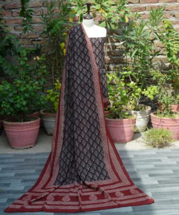 Organic Dye Hand Block Printed Ajrak Floral Butta Un-Stitched Two-Piece (Shirt and Dupatta): A traditional unstitched two-piece set with floral butta and geometric patterns in deep black and red, hand block printed using organic dyes.