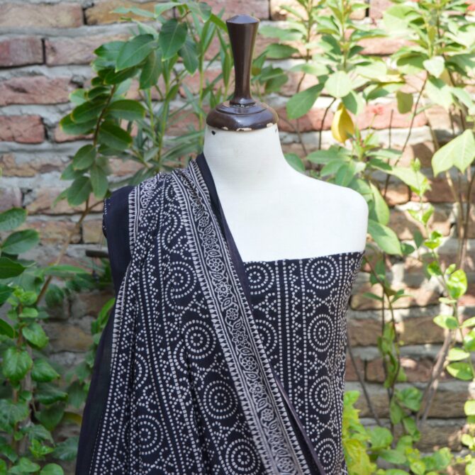 Ajrak Black Chunri Floral, Close-up of the un-stitched shirt featuring intricate hand block printed patterns in deep black, highlighting traditional Ajrak craftsmanship.