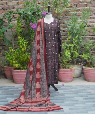 A finely printed black Ajrak kurta with intricate geometric patterns and rich maroon accents, adorned with mirror embroidery on high-quality lawn cotton fabric.