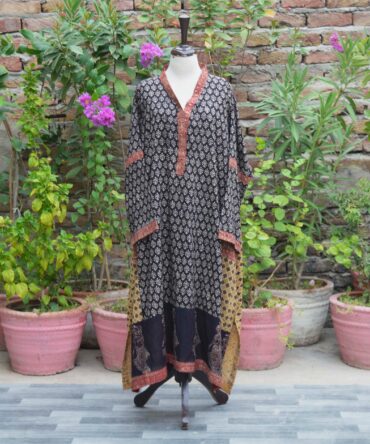 Ajrak Kurta Free Size Displayed on Mannequin: "Organic Dye Hand Block Printed Ajrak Free Size Kurta displayed on a mannequin, showcasing intricate geometric and floral patterns in deep black. The kurta is made of breathable Lawn cotton