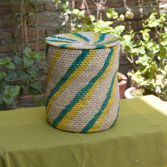 A beautifully crafted laundry basket made from sustainable palm leaves, showcasing its natural texture and elegant design.