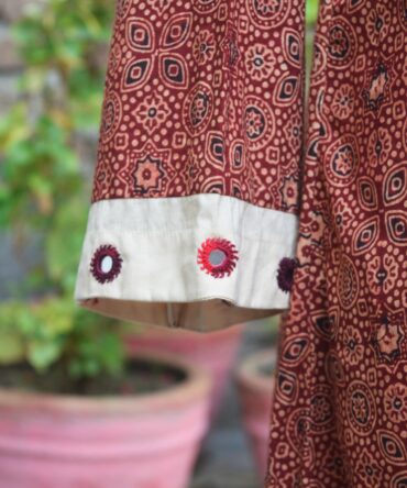 A detailed shot of the hand-block printed Ajrak pattern, highlighting the fine craftsmanship and organic dyes used in the fabric.