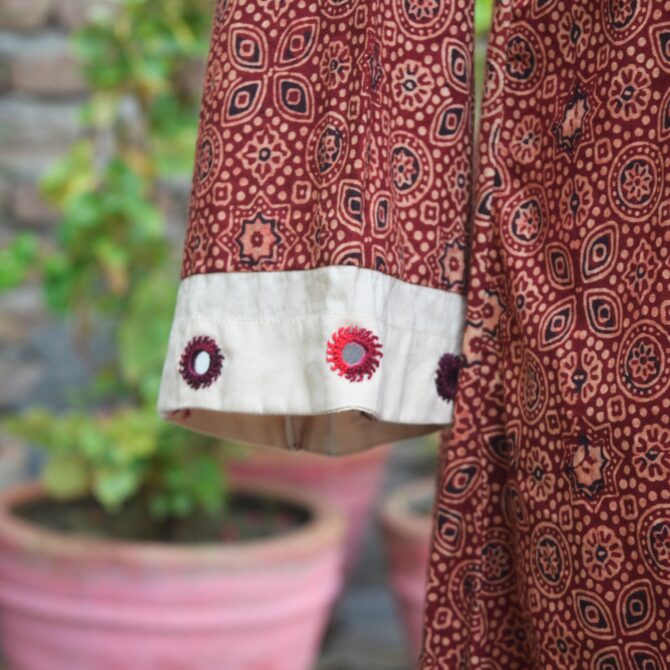 A detailed shot of the hand-block printed Ajrak pattern, highlighting the fine craftsmanship and organic dyes used in the fabric.