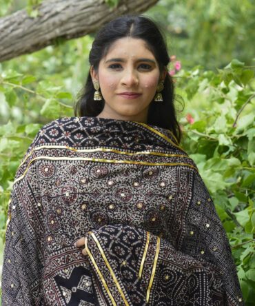 Close-up view of the hand block printing technique on the Ajrak Chaadar, highlighting the detailed patterns and rich organic black dye.