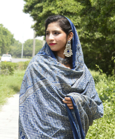 A beautifully handcrafted Organic Dye Hand Block Printed Ajrak Zigzag Odhni in Indigo, showcasing intricate geometric and floral patterns in mehroonish red. The odhni measures 2.5 meters in length and 44 inches in width, made from luxurious Lawn cotton fabric.