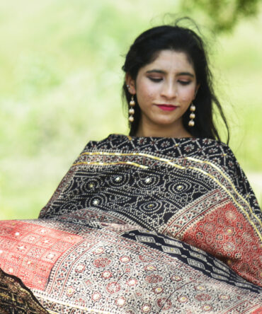 Close-up view of the hand block printing technique on the Black Ajrak Multi Blocks Classic, highlighting the intricate patterns and rich, organic black dye.