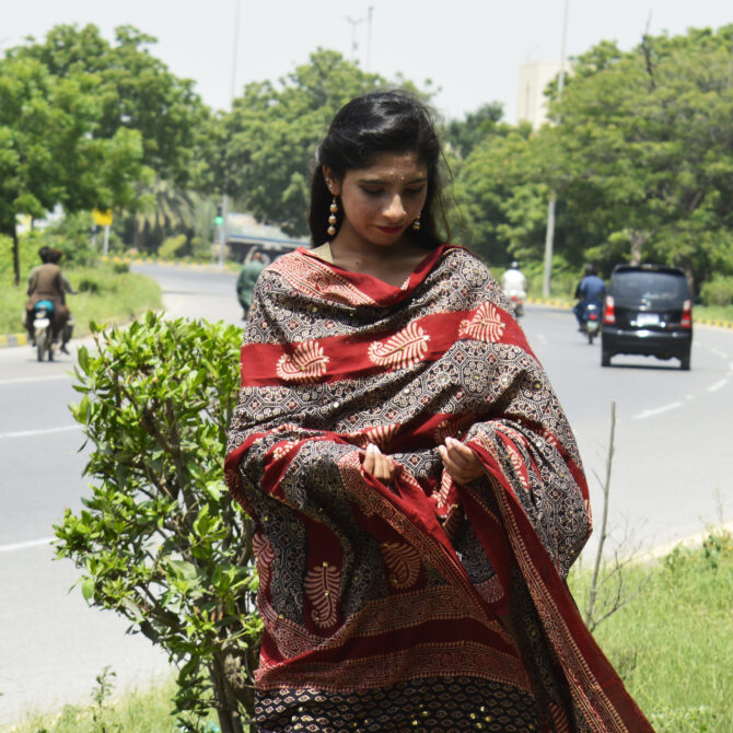 Model wearing an Ajrak Odhni Leafy, showcasing versatile styling with traditional hand block printed patterns and luxurious lawn cotton fabric.