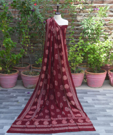 Ajrak Red Anbi Organic Dye Hand Block Printed unstitched two-piece dress featuring a deep red shirt and dupatta with intricate geometric and floral motifs, showcasing traditional craftsmanship.